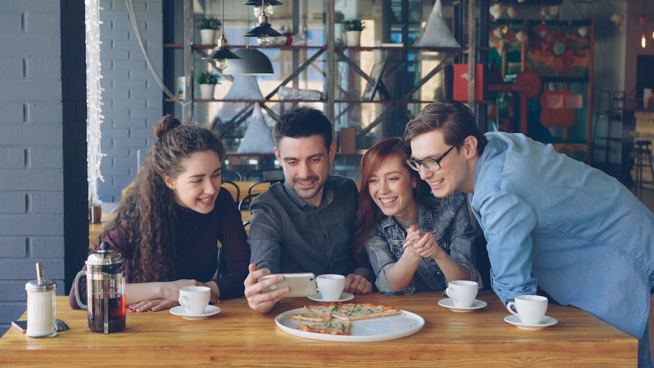 Young adults laughing together during a casual brunch in a cafe
