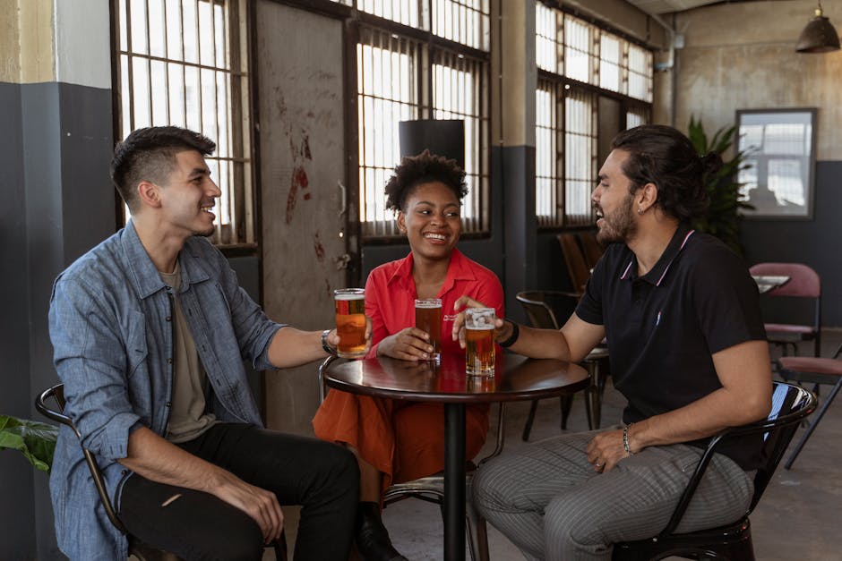 Diverse friends laughing together around a cafe table during a casual meetup