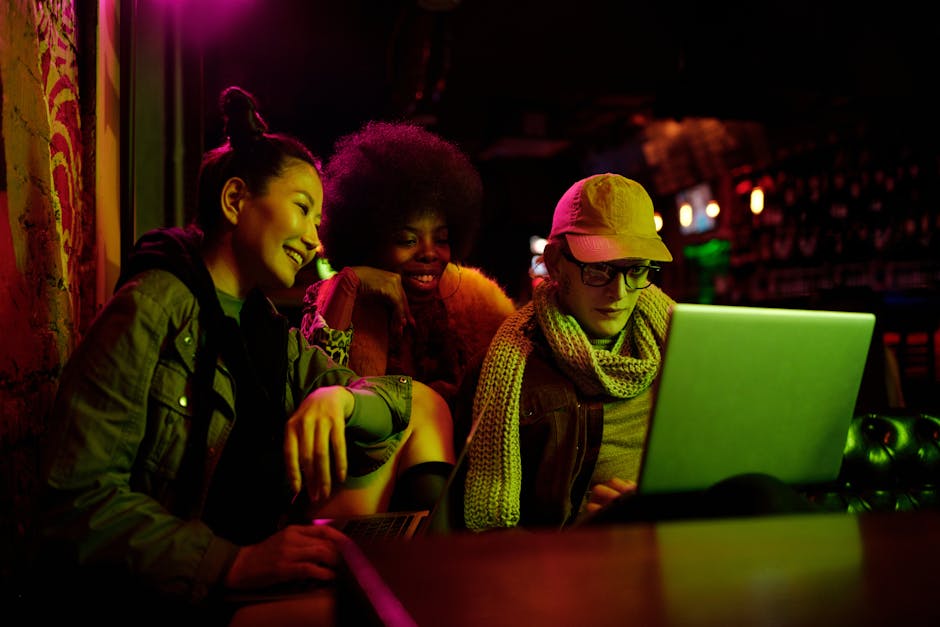 Young woman smiling beside a laptop in a relaxed cafe setting