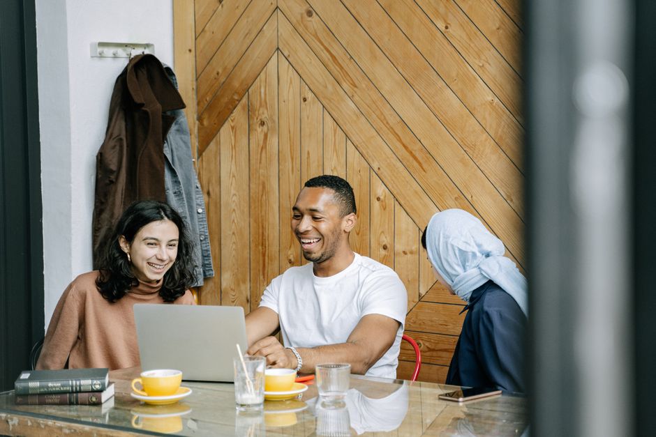 Young colleagues laughing together in a bright coworking space