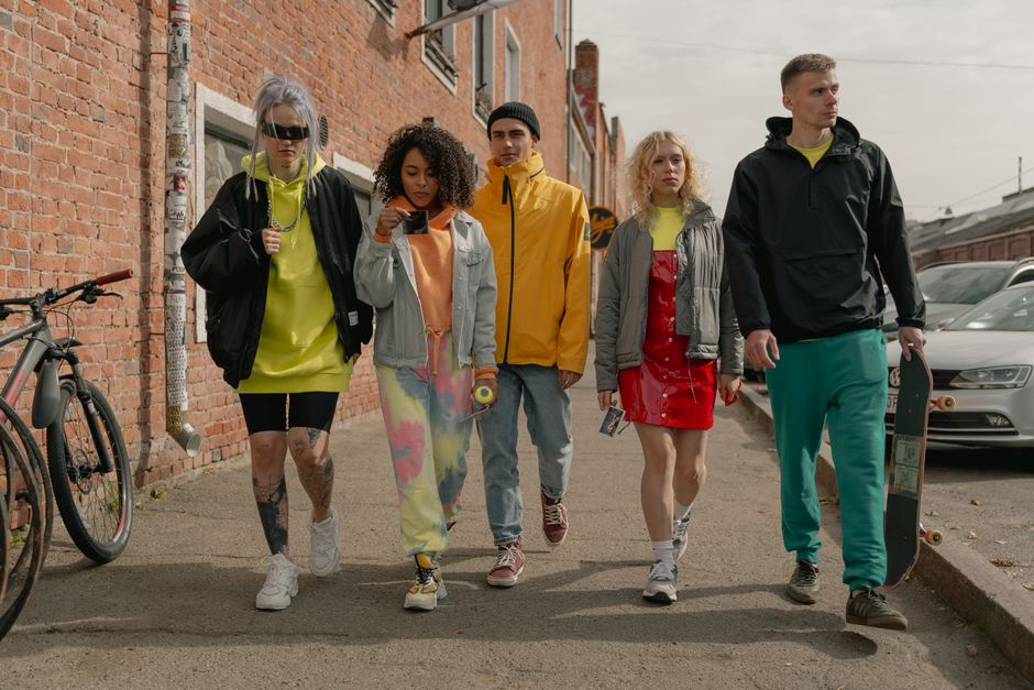 Diverse friends walk together through a sunny urban street