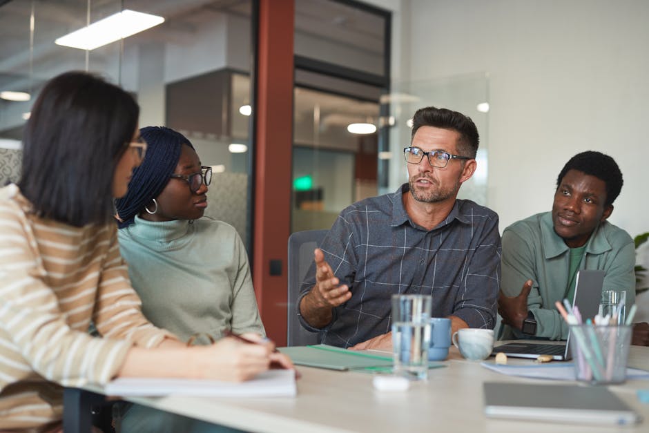 Young colleagues talking casually in a modern coworking space