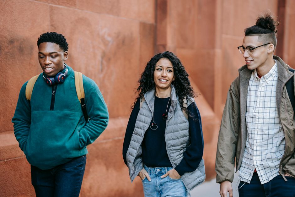 Young adults walking together along a bright urban street
