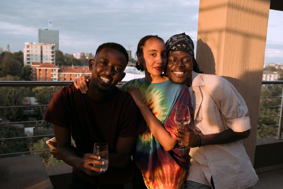 Young colleagues smiling together on an outdoor brunch terrace