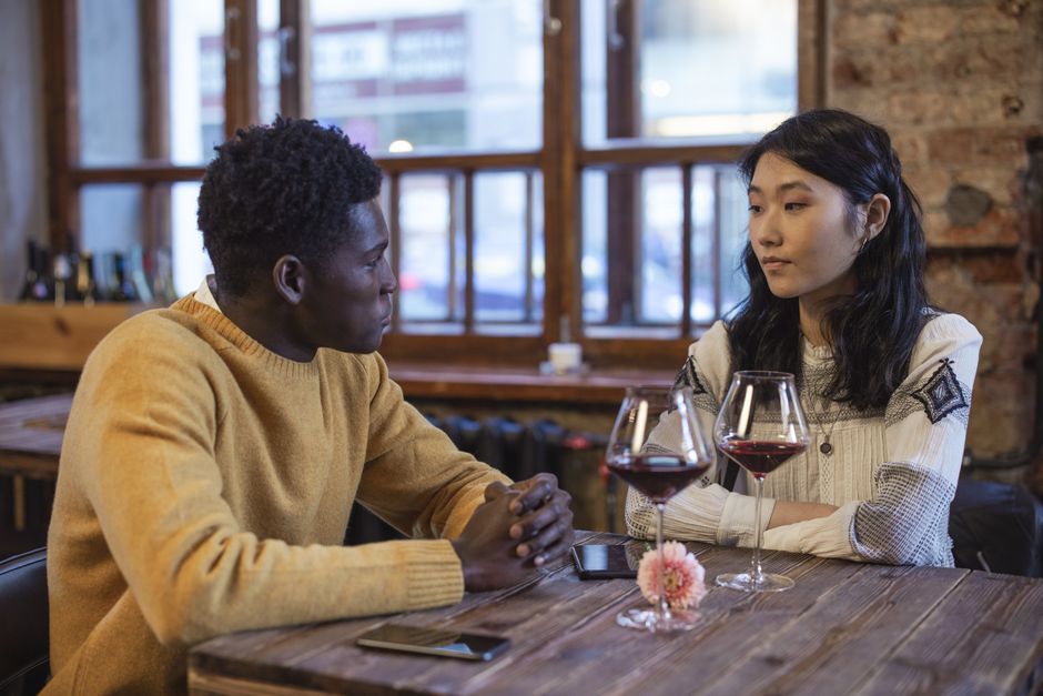 Diverse friends chatting around a cafe table with coffee cups