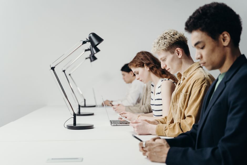 Young colleagues typing on laptops in a coworking space during a practical workshop