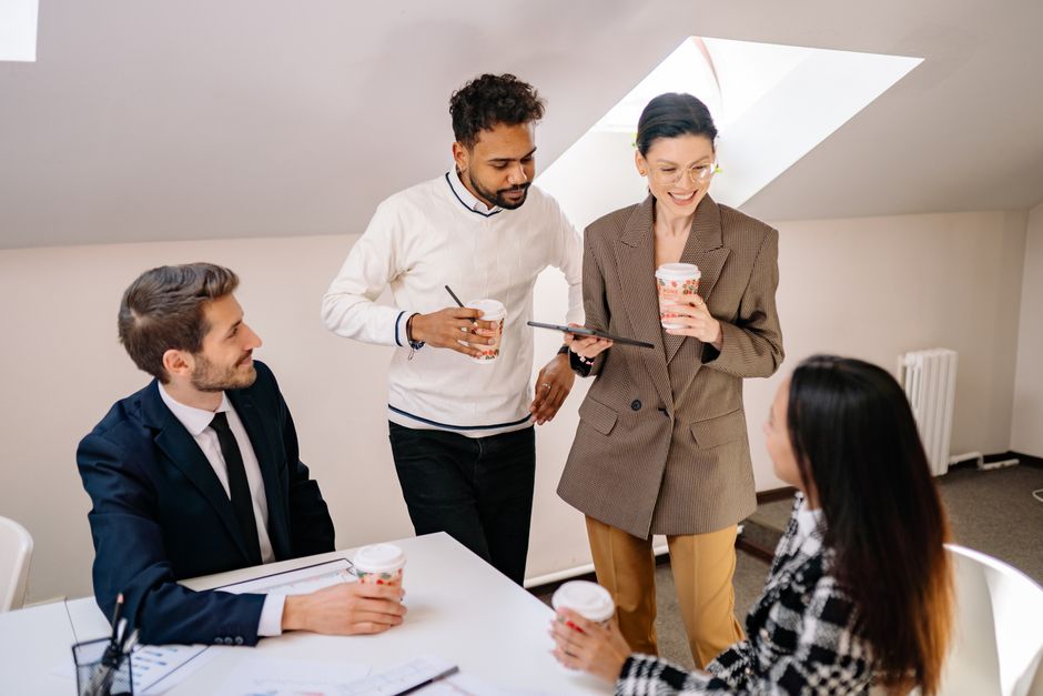 Young colleagues drinking coffee together in a relaxed coworking space
