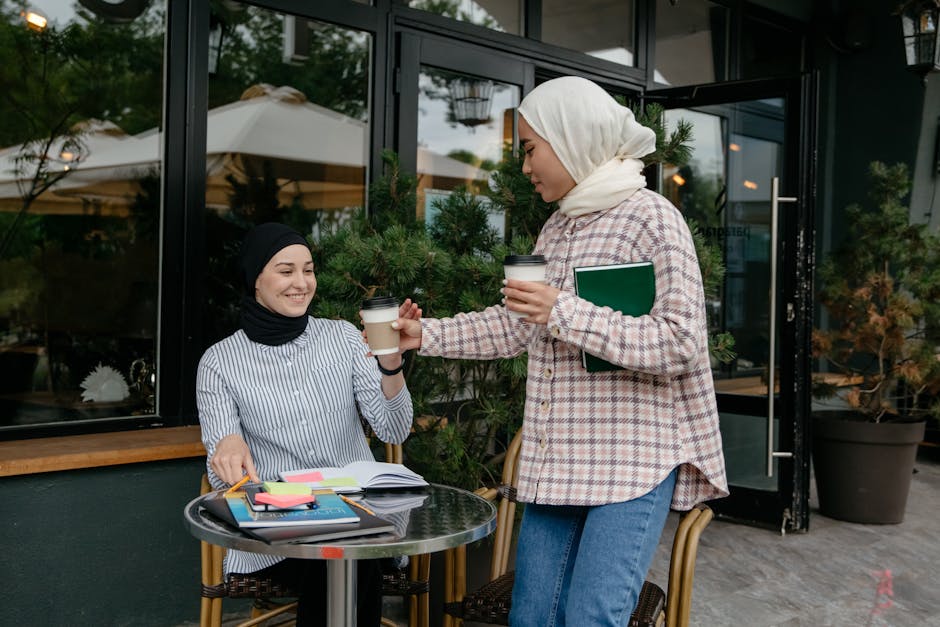 Young woman smiling with a notebook and coffee in a cozy cafe corner