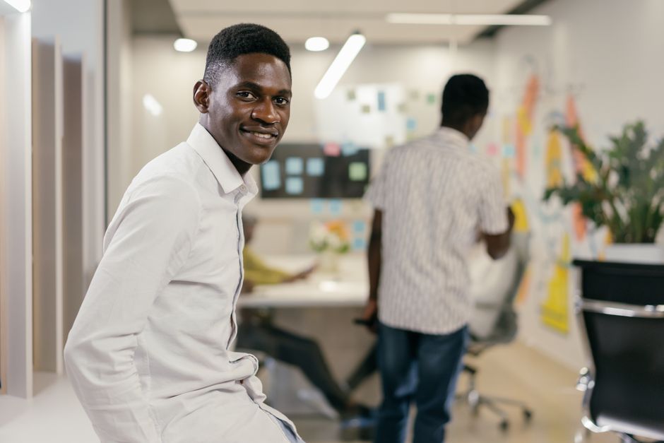 Remote workers smiling together while sitting in a relaxed coworking space